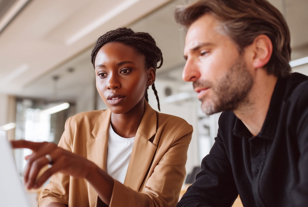 Man and woman looking at monitor