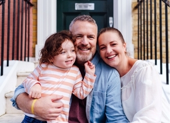 Happy family outside of house
