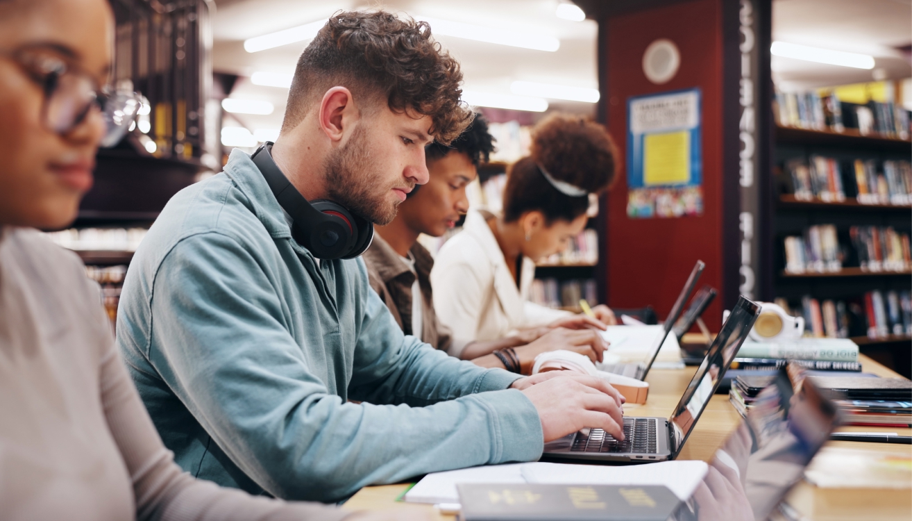 Students on laptop in library