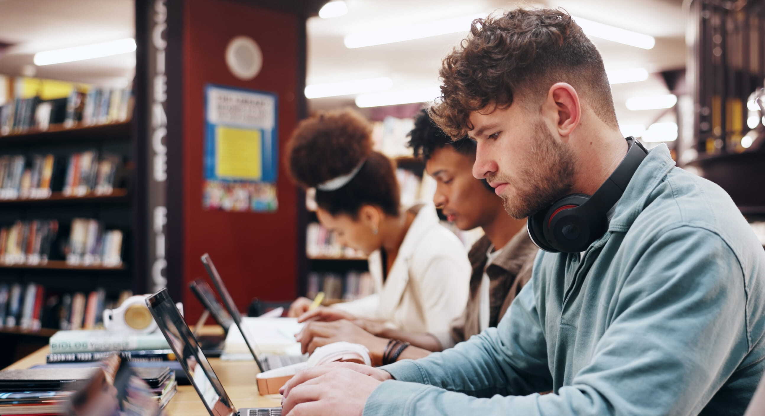 Students on laptop in library