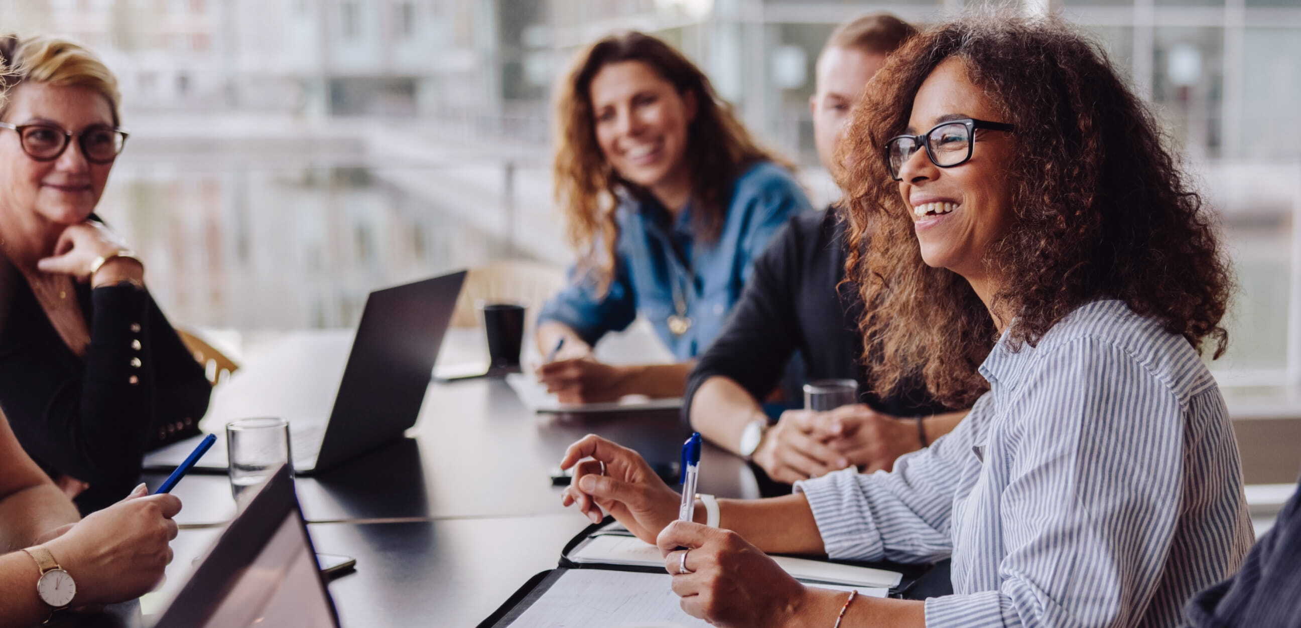 People in meeting room smiling