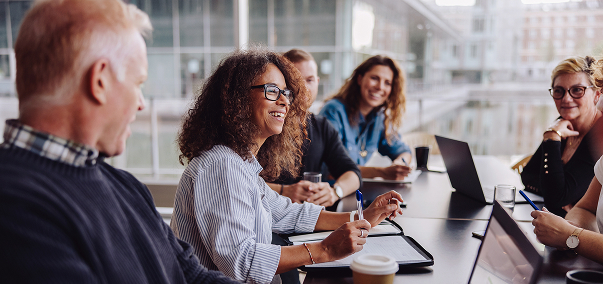 People smiling and discussing in a meeting room