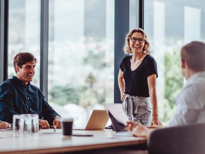 People talking and smiling in meeting room