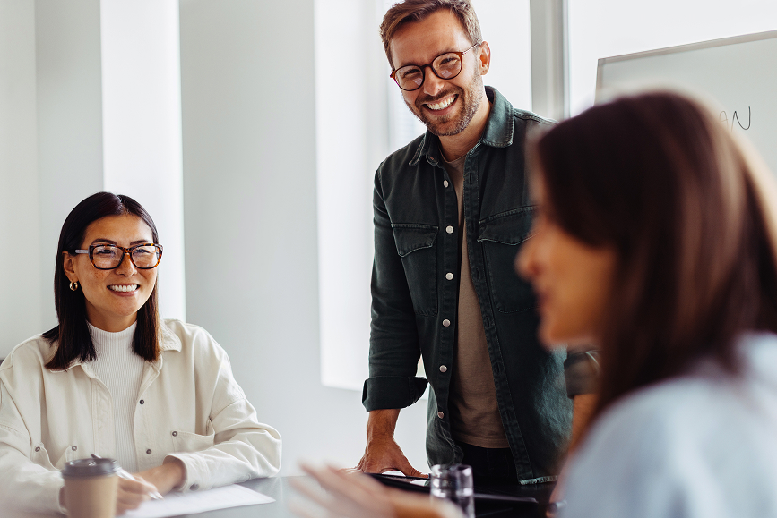 Three people in a meeting room