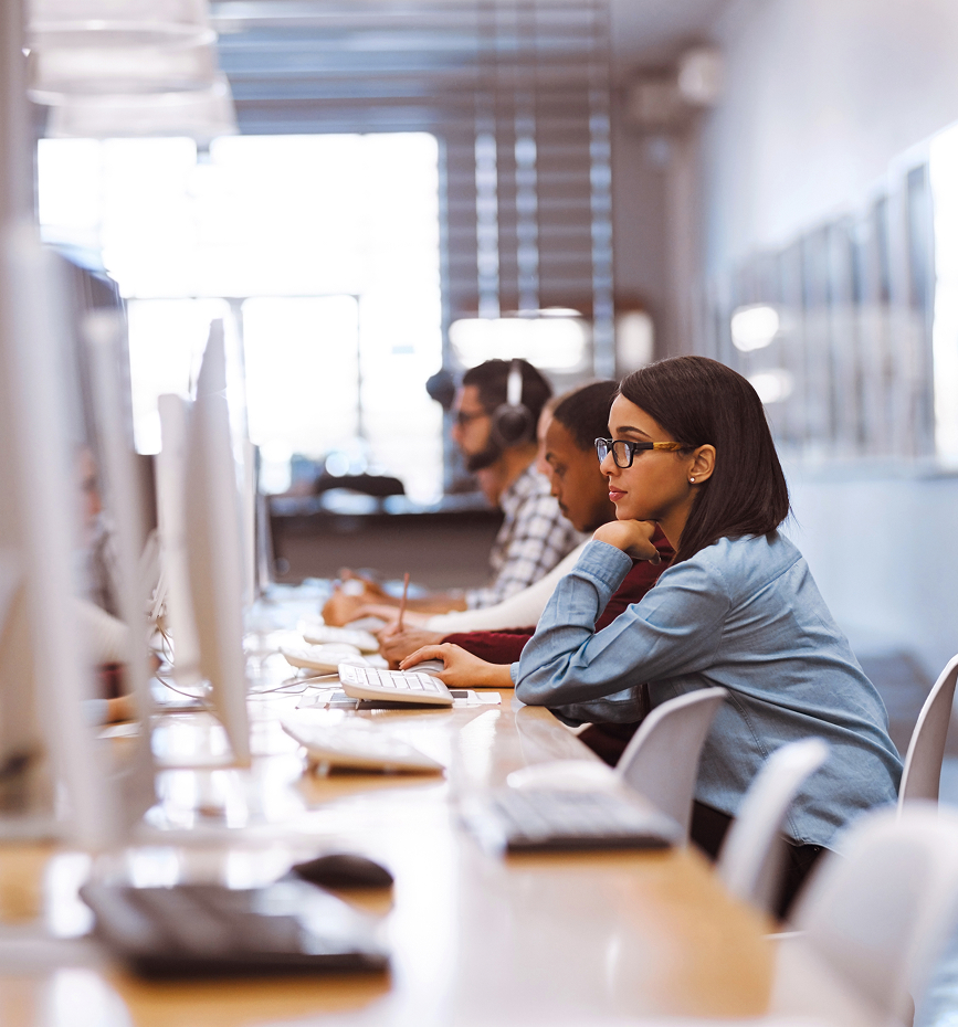 Woman sat at desk looking at monitor