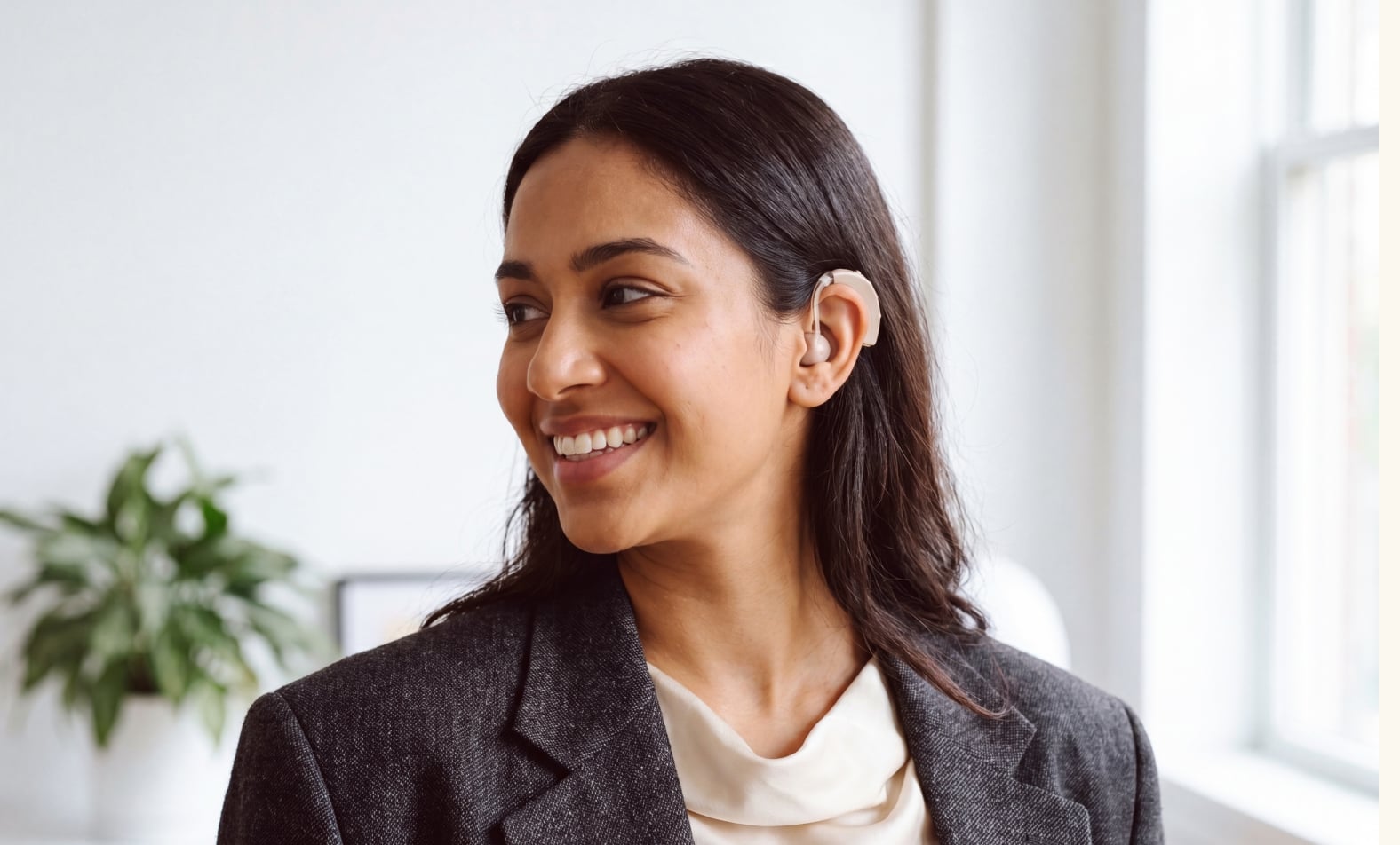 Person with hearing aid smiling