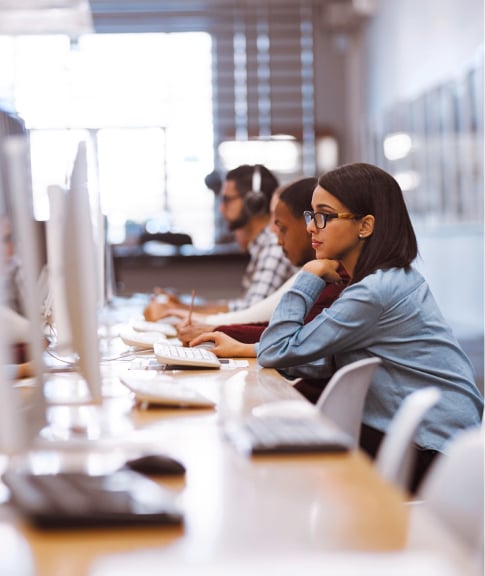 About-Carousel-Looking-Down-A-Line-Of-Desks-In-Office