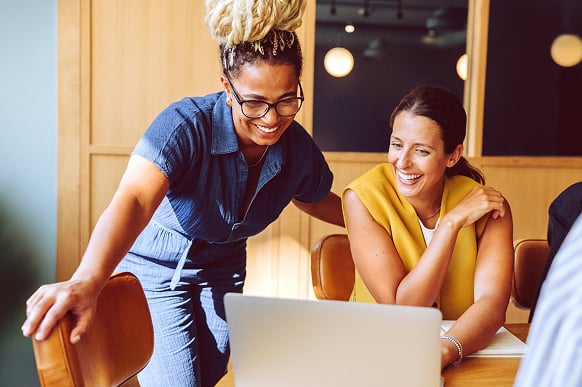 About-Carousel-Two-Women-Talking-At-A-Laptop