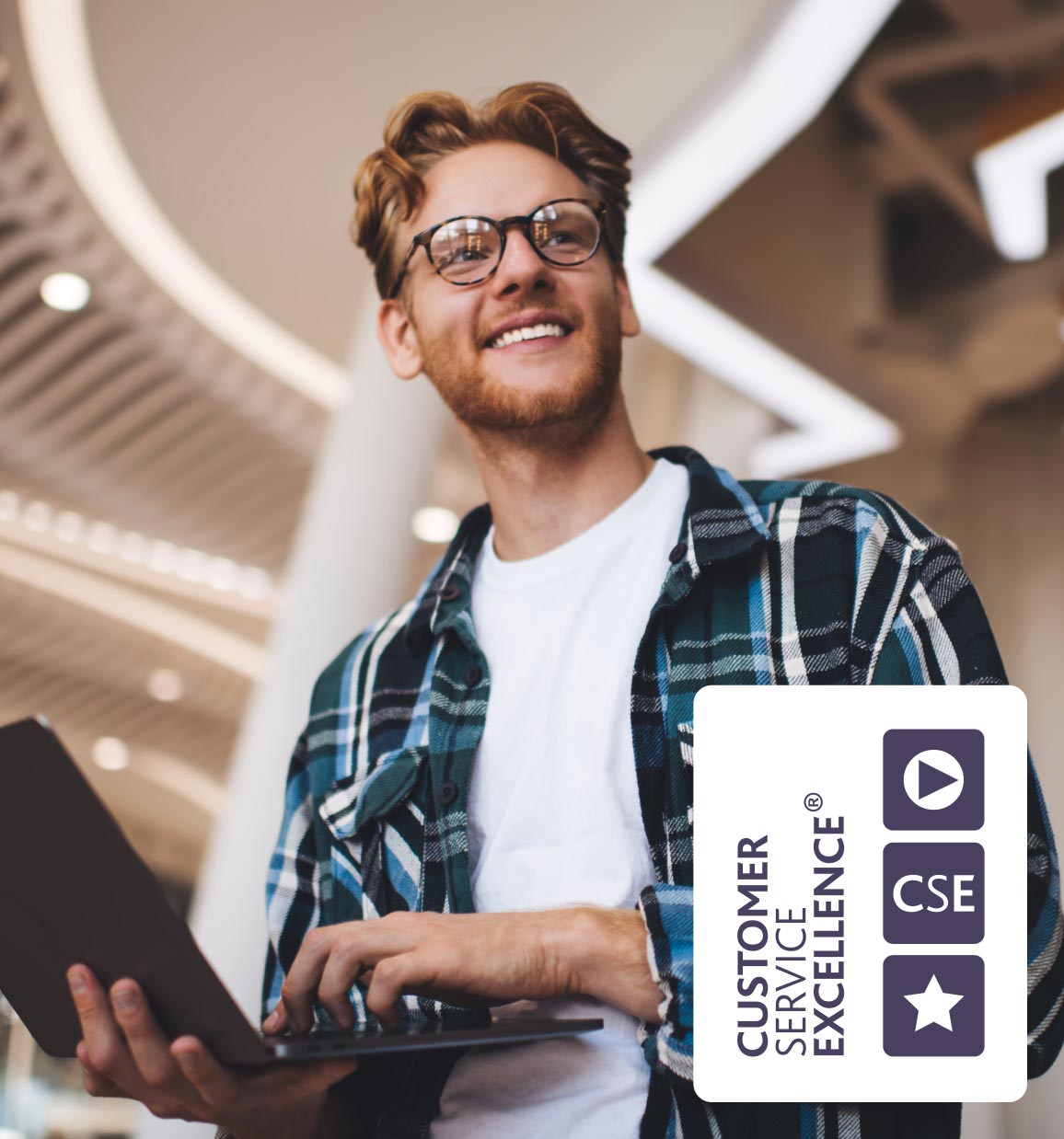 Man holding laptop smiling