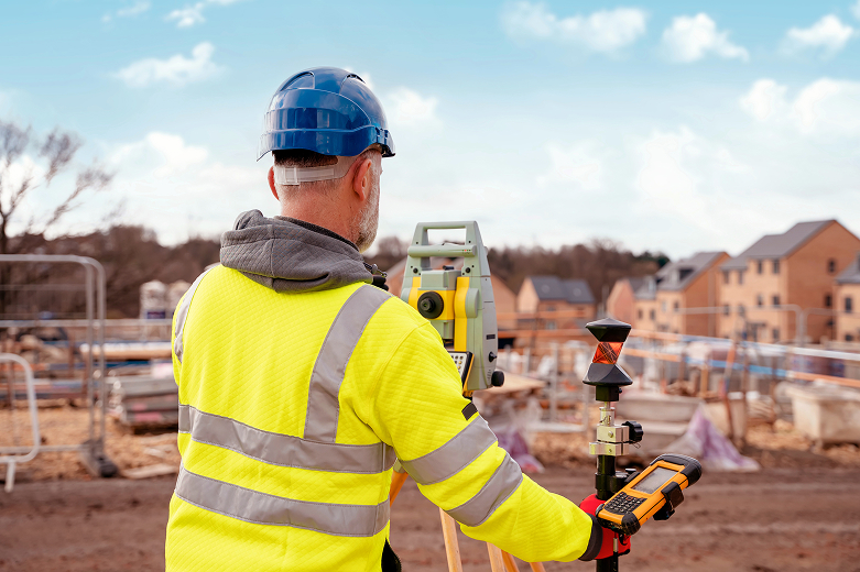 Building surveying new house building site